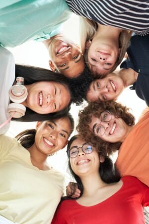 Vertical photo of a multiracial group of friends taking a selfie