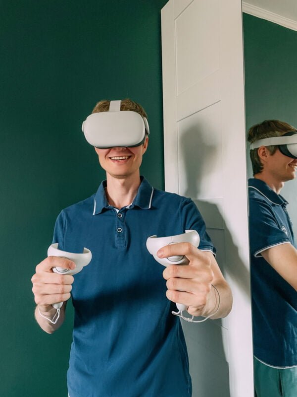 Young man playing a game with VR glasses.